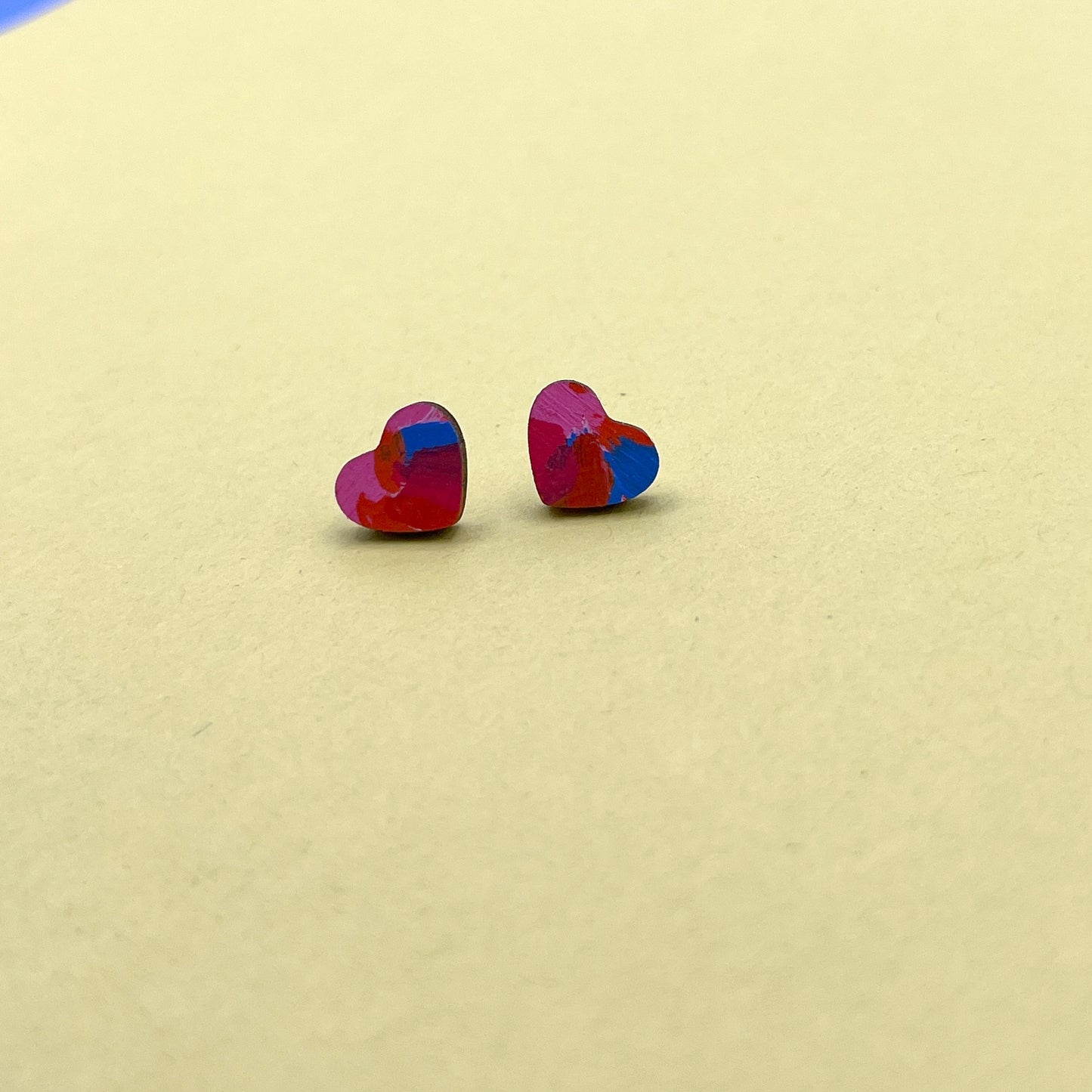 Heart-shaped earrings on a beige background