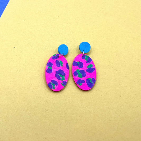Pair of colorful earrings on a yellow background