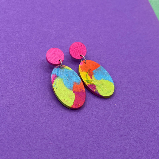 Colorful earrings on a purple background